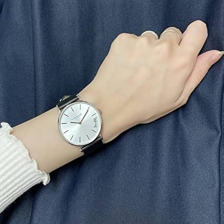 Coach Perry white dial watch worn on wrist with black leather strap