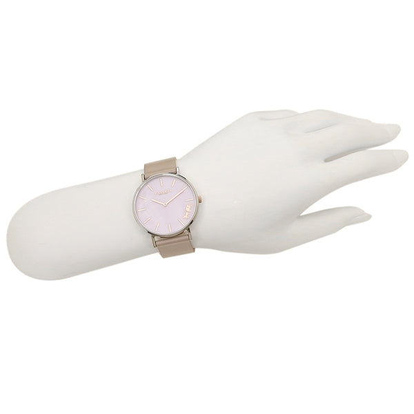 Coach Perry lilac mother of pearl watch worn on wrist with taupe strap