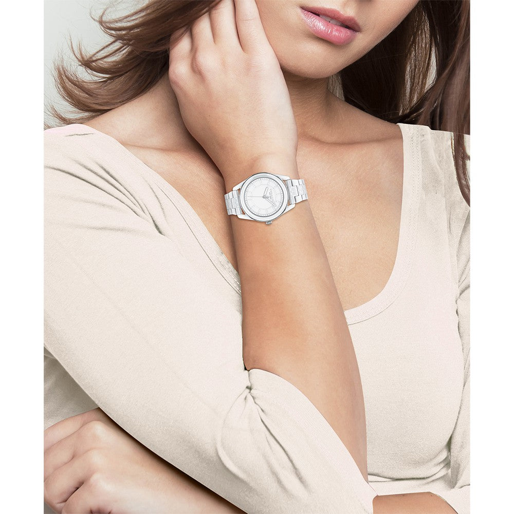 Coach Preston white ceramic watch worn on womens wrist with white dial