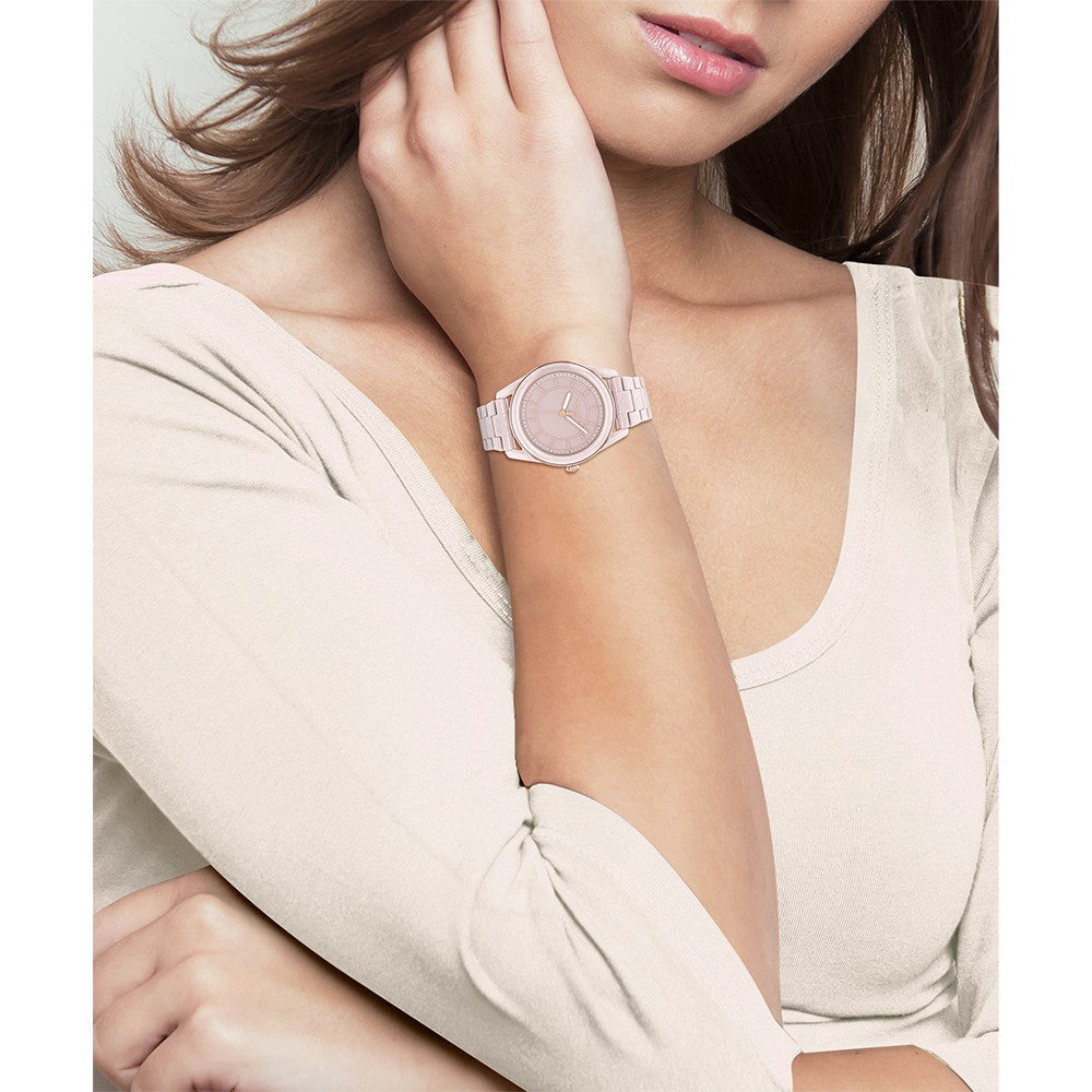 Coach Preston blush ceramic watch worn on wrist with matching blush ceramic band