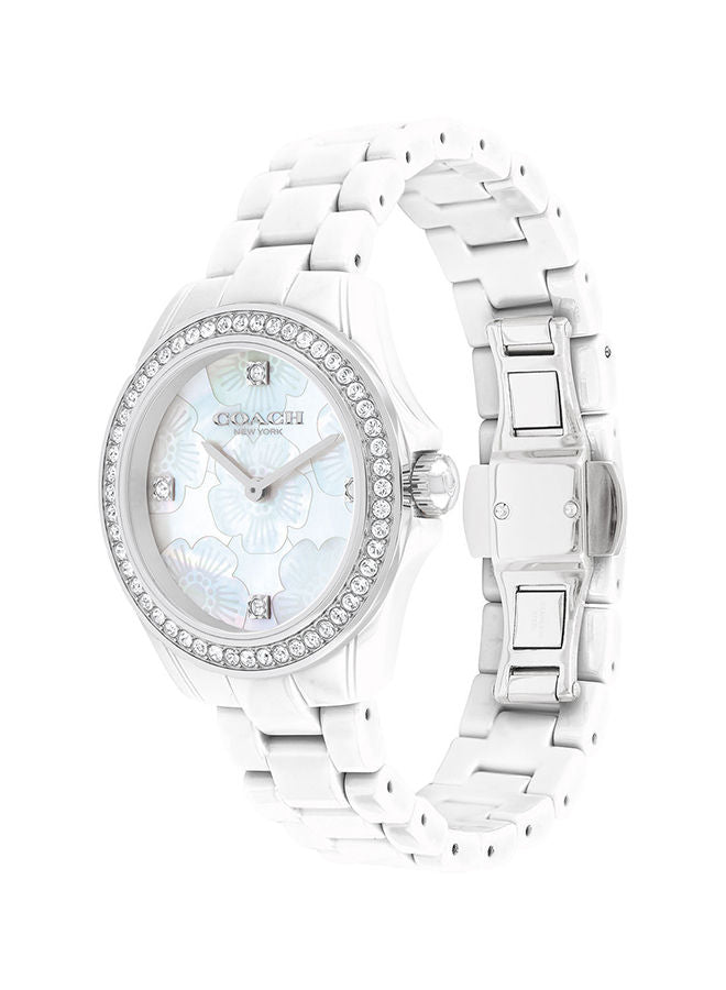Coach Preston ceramic watch displayed at angle showing white ceramic band and bezel detail