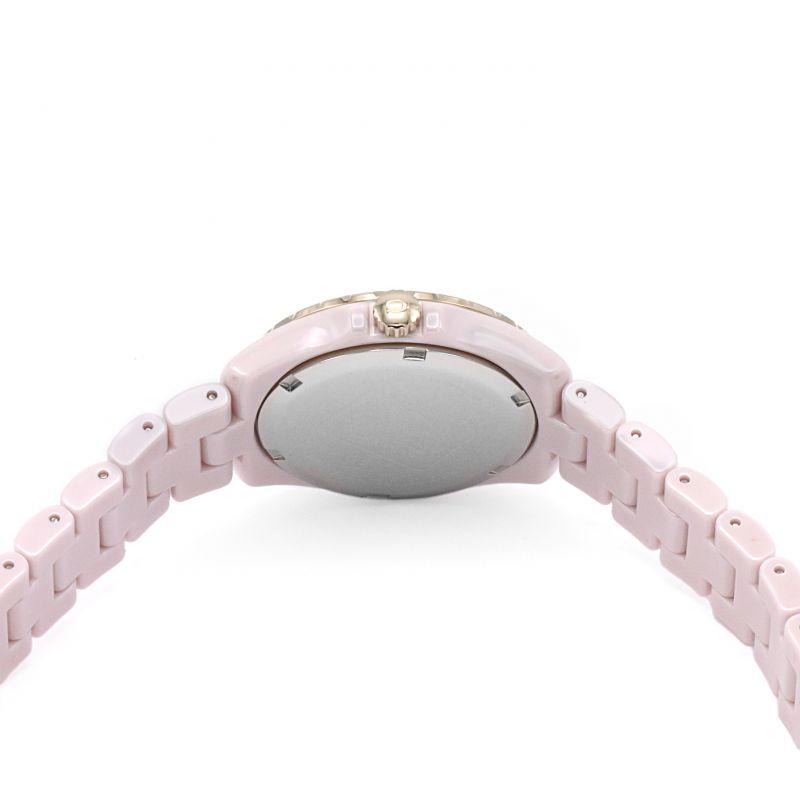 Coach Preston pink ceramic watch shown from side view with crown and caseback visible