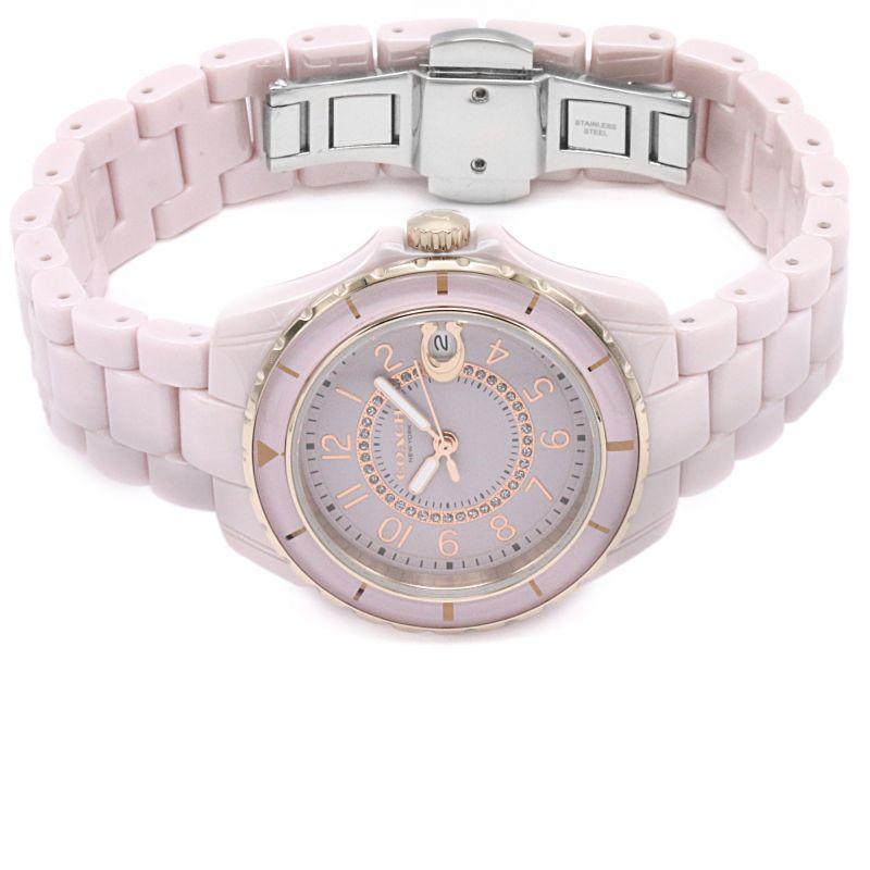 Coach Preston pink ceramic bracelet watch worn on wrist showing full band and clasp
