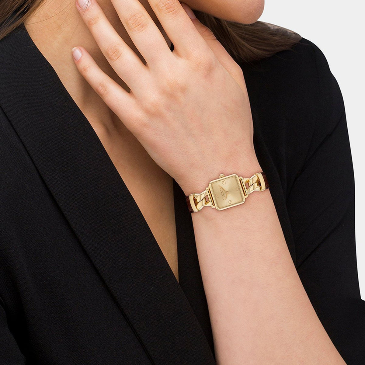 Coach Ladies Watch worn on wrist, showcasing square gold-tone case and chain-link bracelet