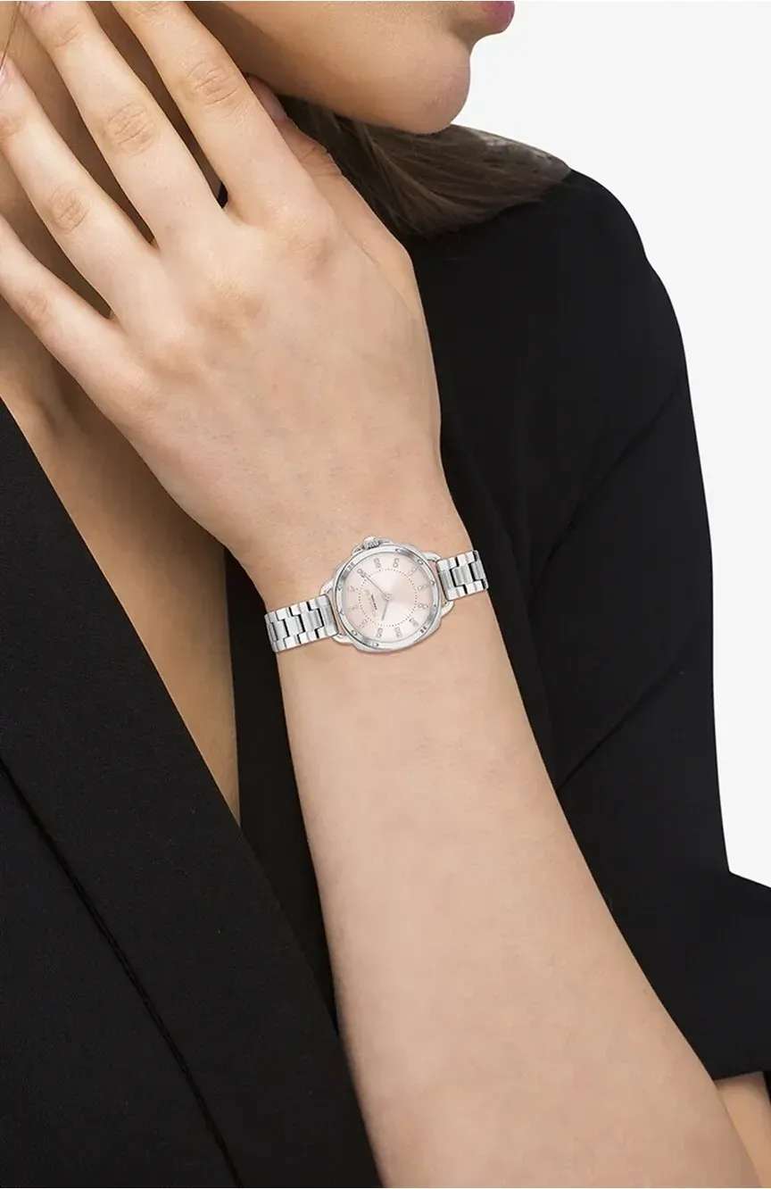 Coach Tatum women's watch worn on wrist showing pink dial and stainless steel bracelet