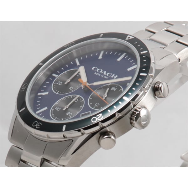 Side angle of Coach Thompson watch showing silver metal case, black bezel, chronograph subdials, and metal bracelet