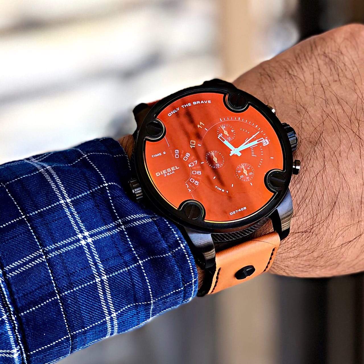 Diesel Daddy DZ7408 on wrist with orange dial and brown leather strap detail