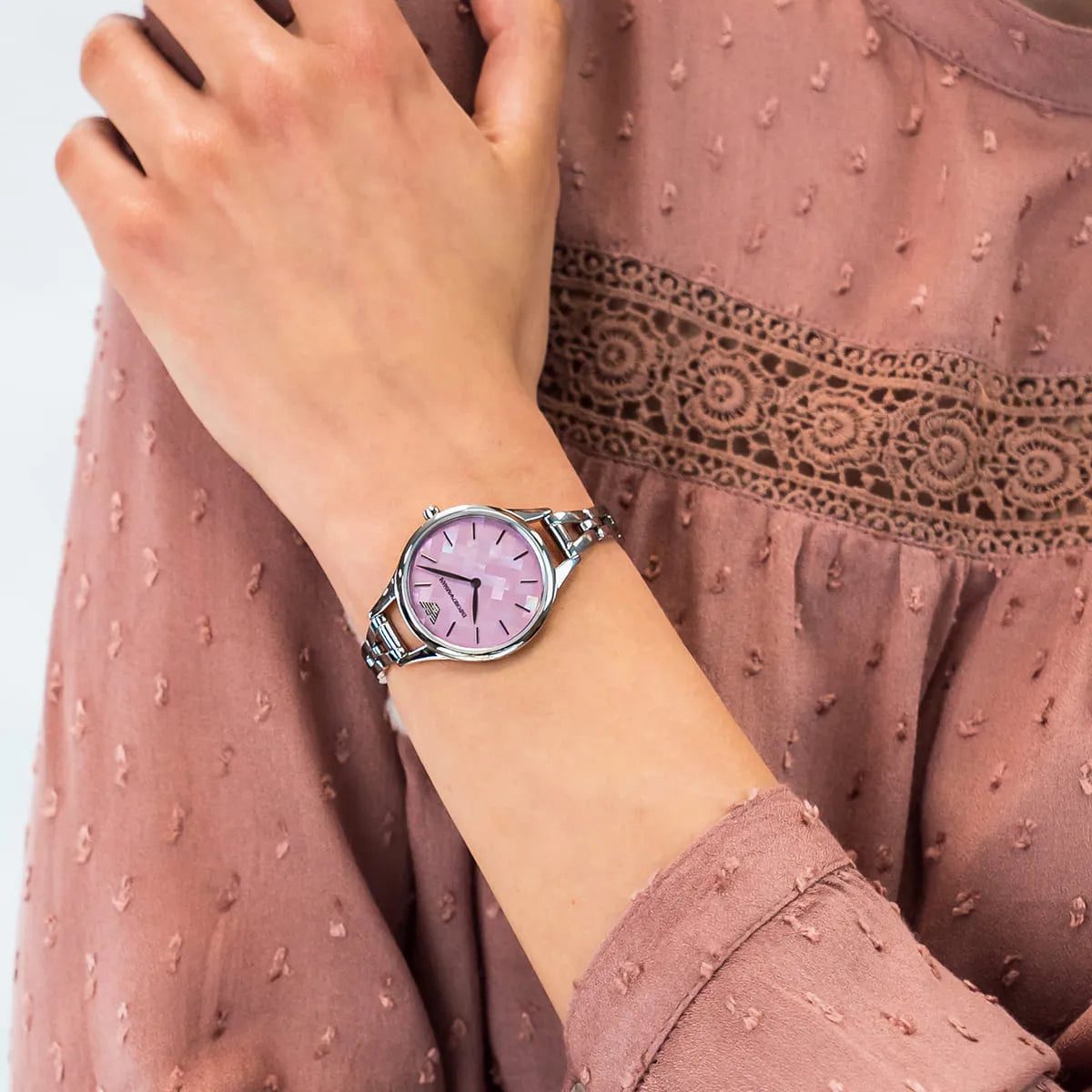 Emporio Armani Aurora watch on wrist with silver steel case and pink dial
