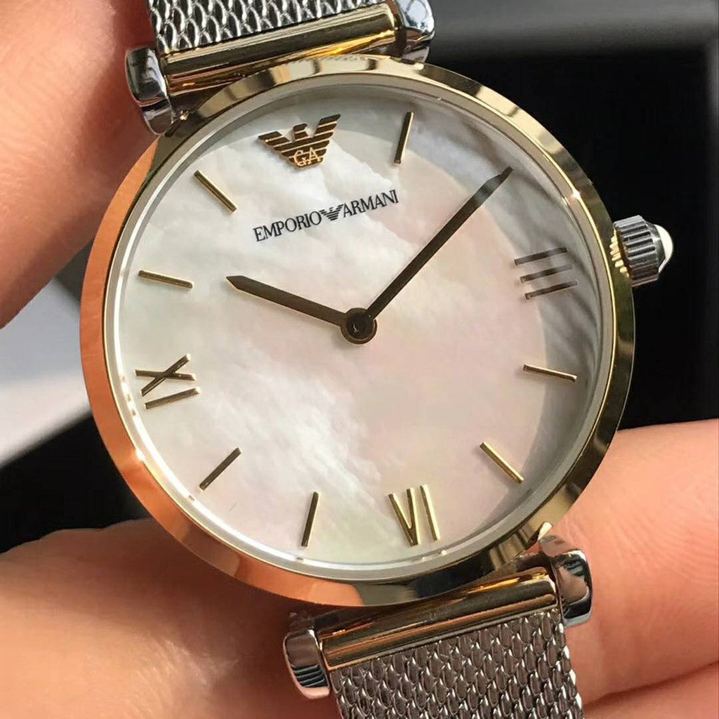 Close-up of mother of pearl dial with roman numerals and Emporio Armani branding
