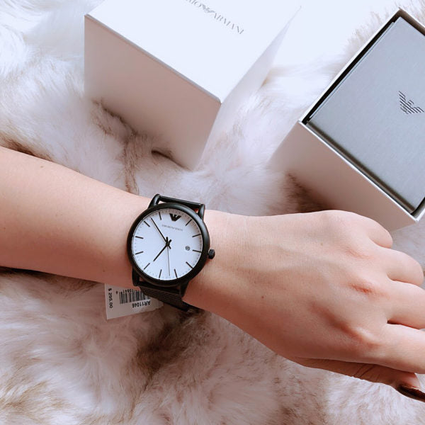 Emporio Armani Luigi watch worn on wrist with black mesh band and packaging visible
