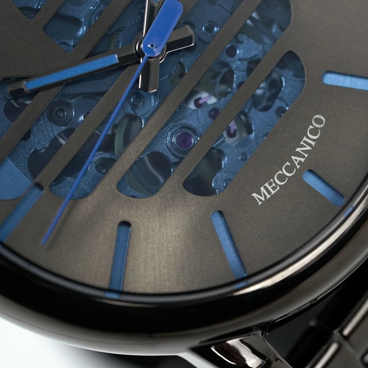 Detailed macro view of Meccanico dial showing mechanical movement, hands, and blue elements