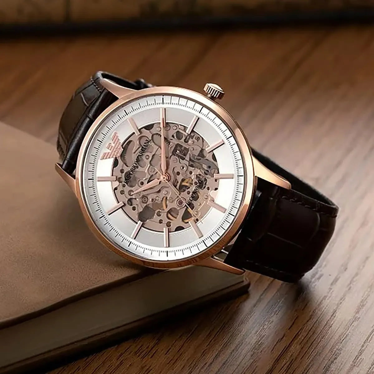 Detailed view of Meccanico automatic skeleton dial with visible movement on brown surface
