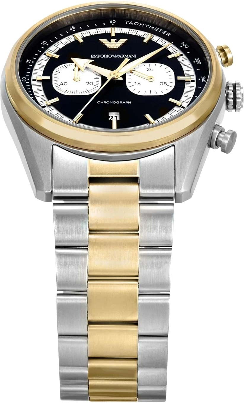 Close-up of black chronograph dial with white subdials, tachymeter bezel, and date window