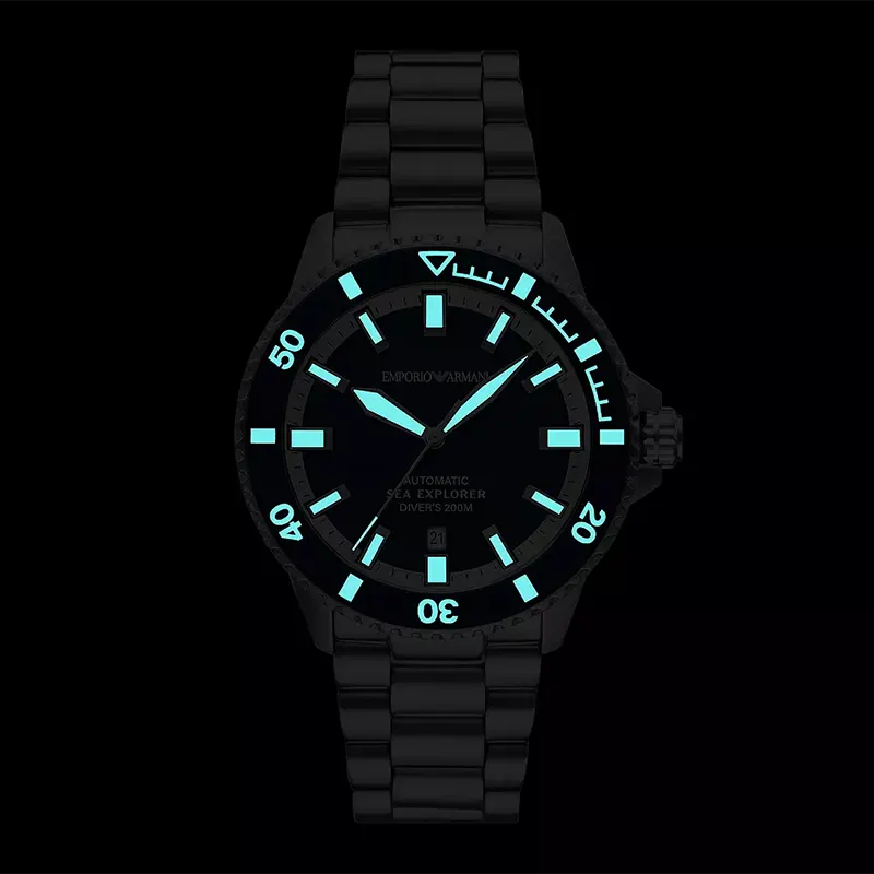 Sea Explorer dial closeup showing luminous hands and hour markers on dark blue face