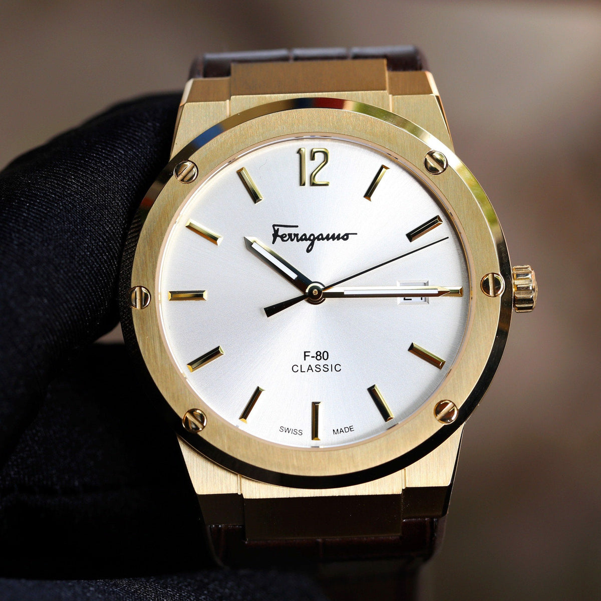 Ferragamo F-80 Classic watch front view with gold case, white dial, and steel bracelet
