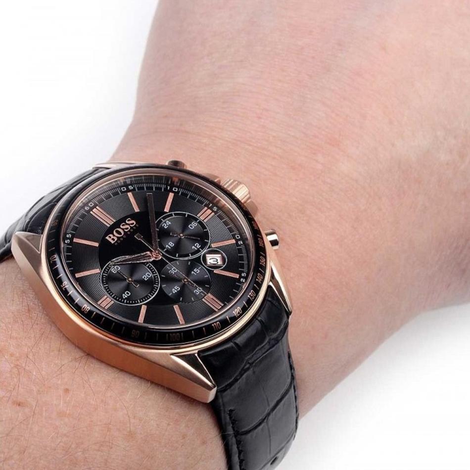 Hugo Boss rose gold chronograph watch with black dial worn on wrist with black leather strap