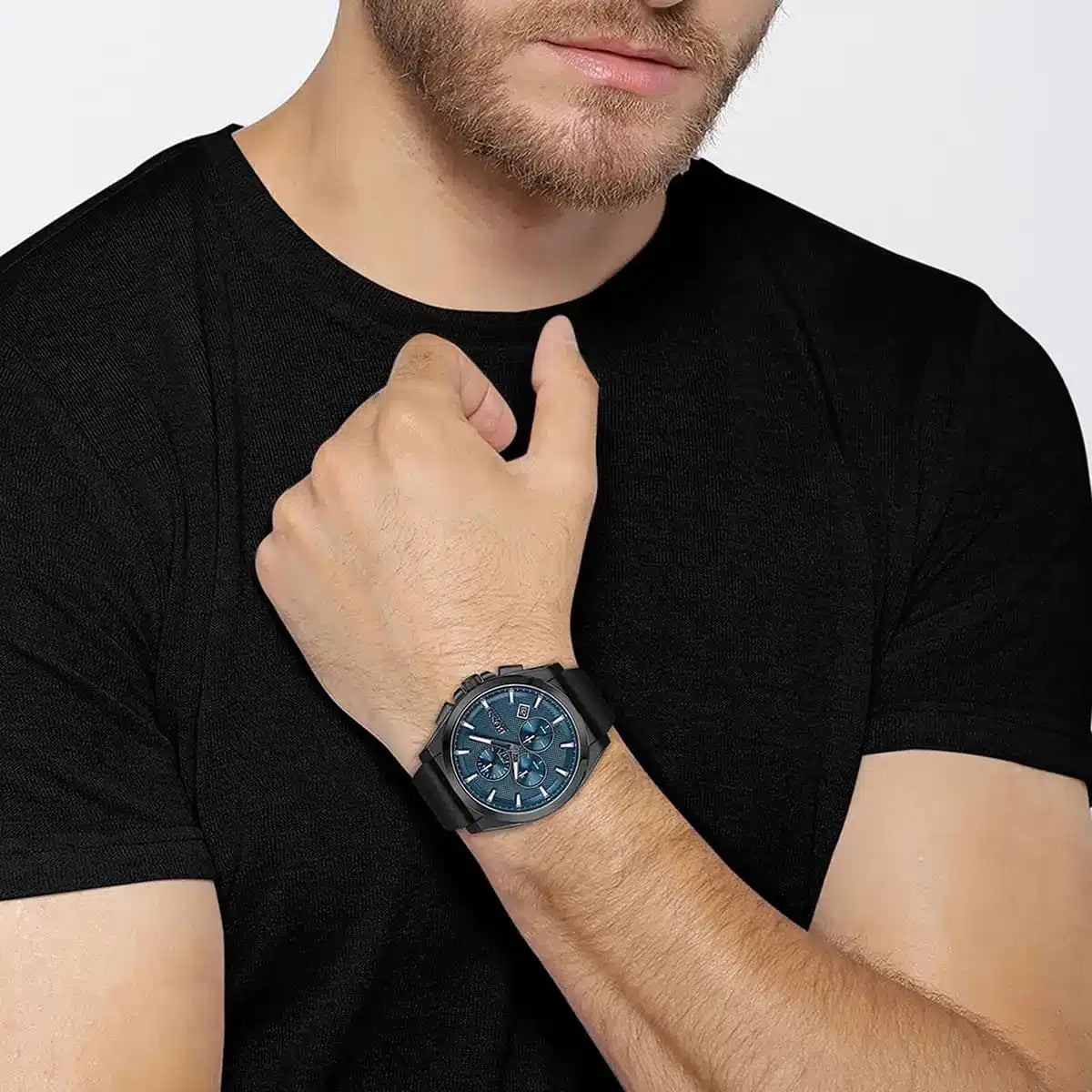 Man wearing Hugo Boss Grandmaster watch with black leather strap and blue chronograph dial