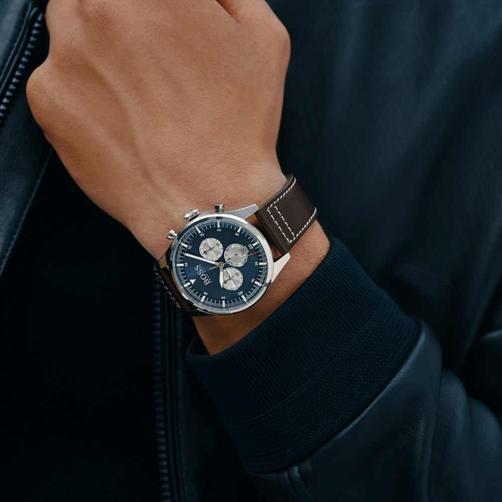 Hugo Boss Pioneer chronograph watch worn on wrist with blue dial and brown leather strap