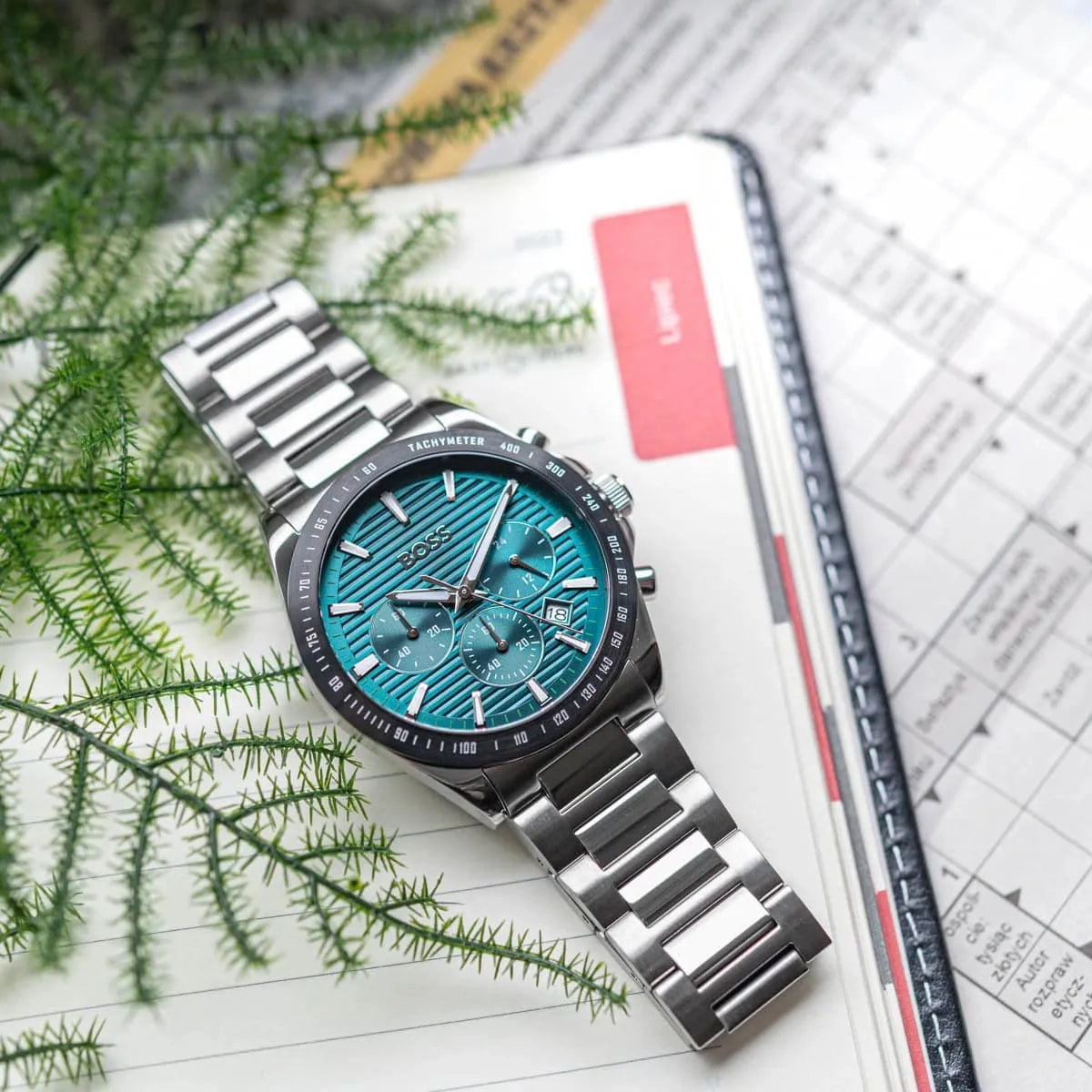 Hugo Boss Strike watch on wrist with green dial and stainless steel bracelet