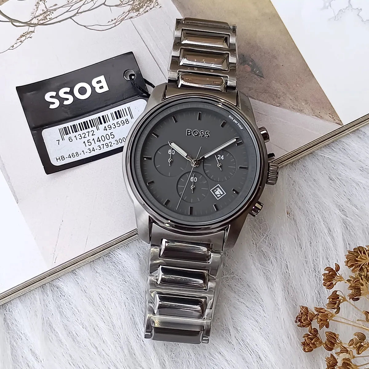 Hugo Boss Trace chronograph watch with tag on white textured surface