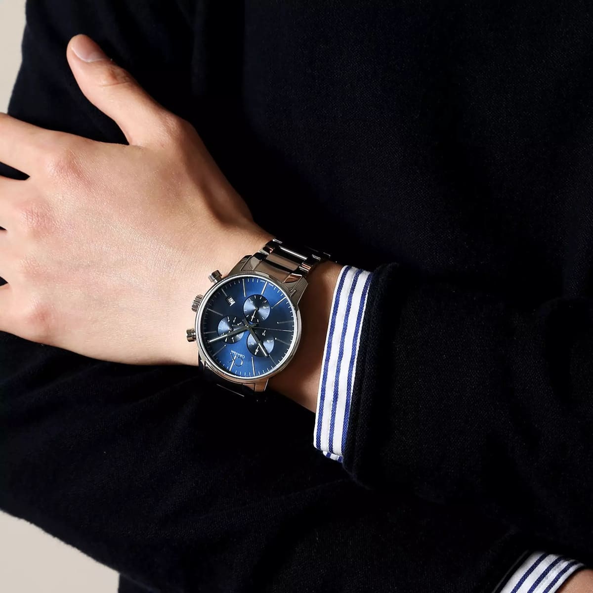 Calvin Klein City chronograph watch worn on wrist with striped fabric accent