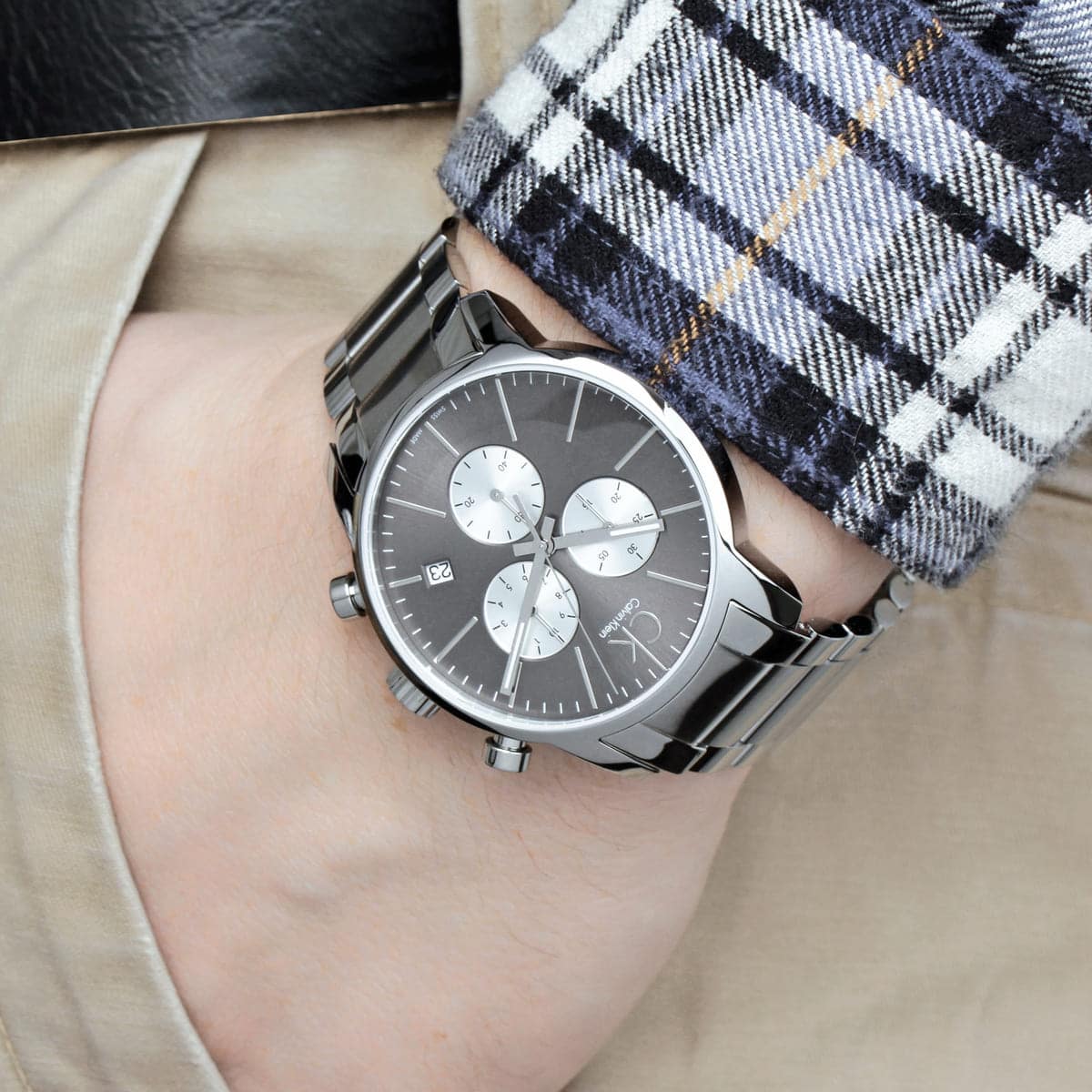 Calvin Klein City K2G2714X chronograph watch worn on wrist with black dial and silver steel bracelet