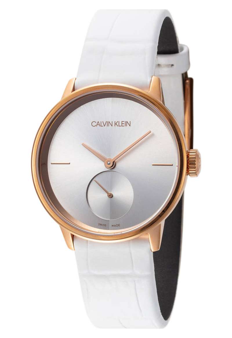 Calvin Klein Accent watch at 45-degree angle showing rose gold case, silver dial, and white leather strap