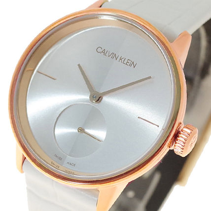 Close-up detail of Calvin Klein Accent dial with silver face, rose gold hands, and subdial