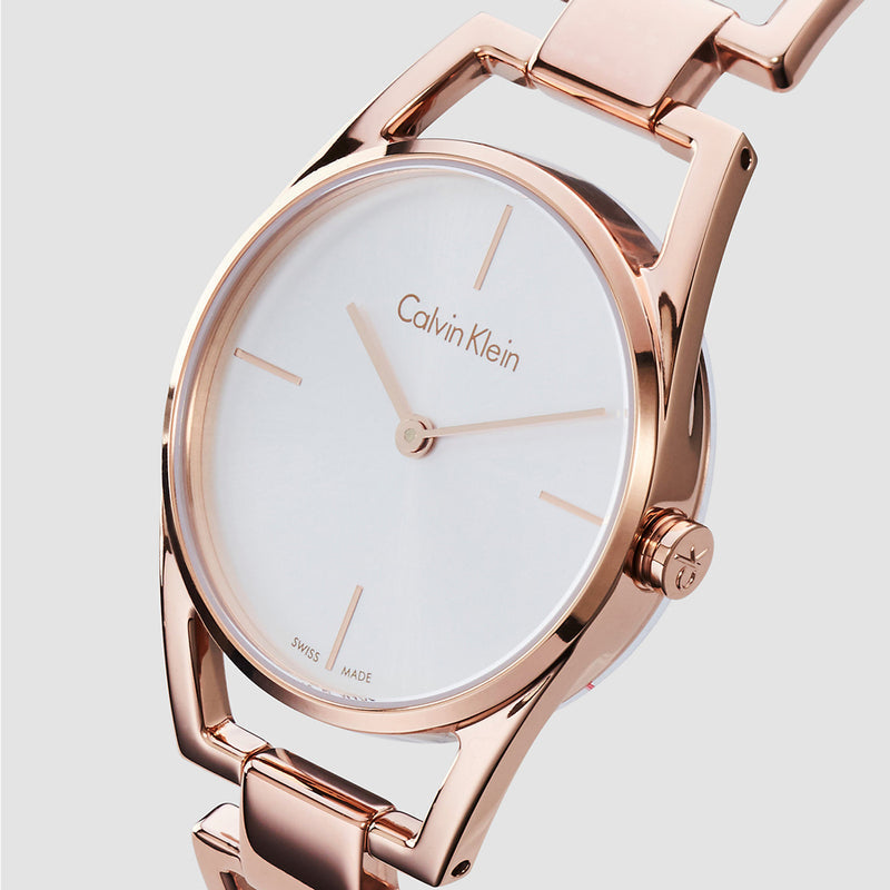 Angled view of Calvin Klein Dainty watch displaying dial with rose gold hands and markers