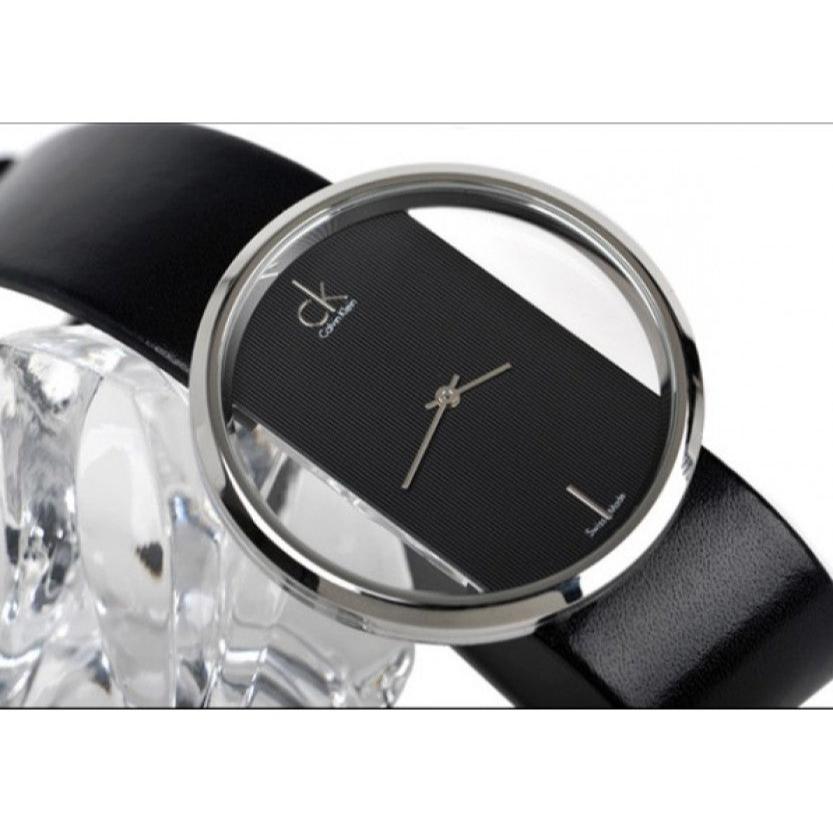 Calvin Klein Glam dial close-up showing transparent face with white hands