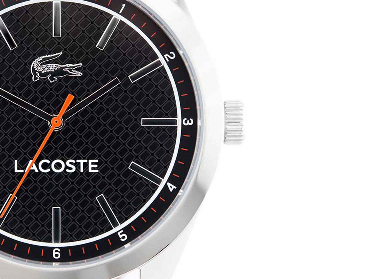 Lacoste 2010888 dial detail with black textured face, white bar indices, and orange seconds hand