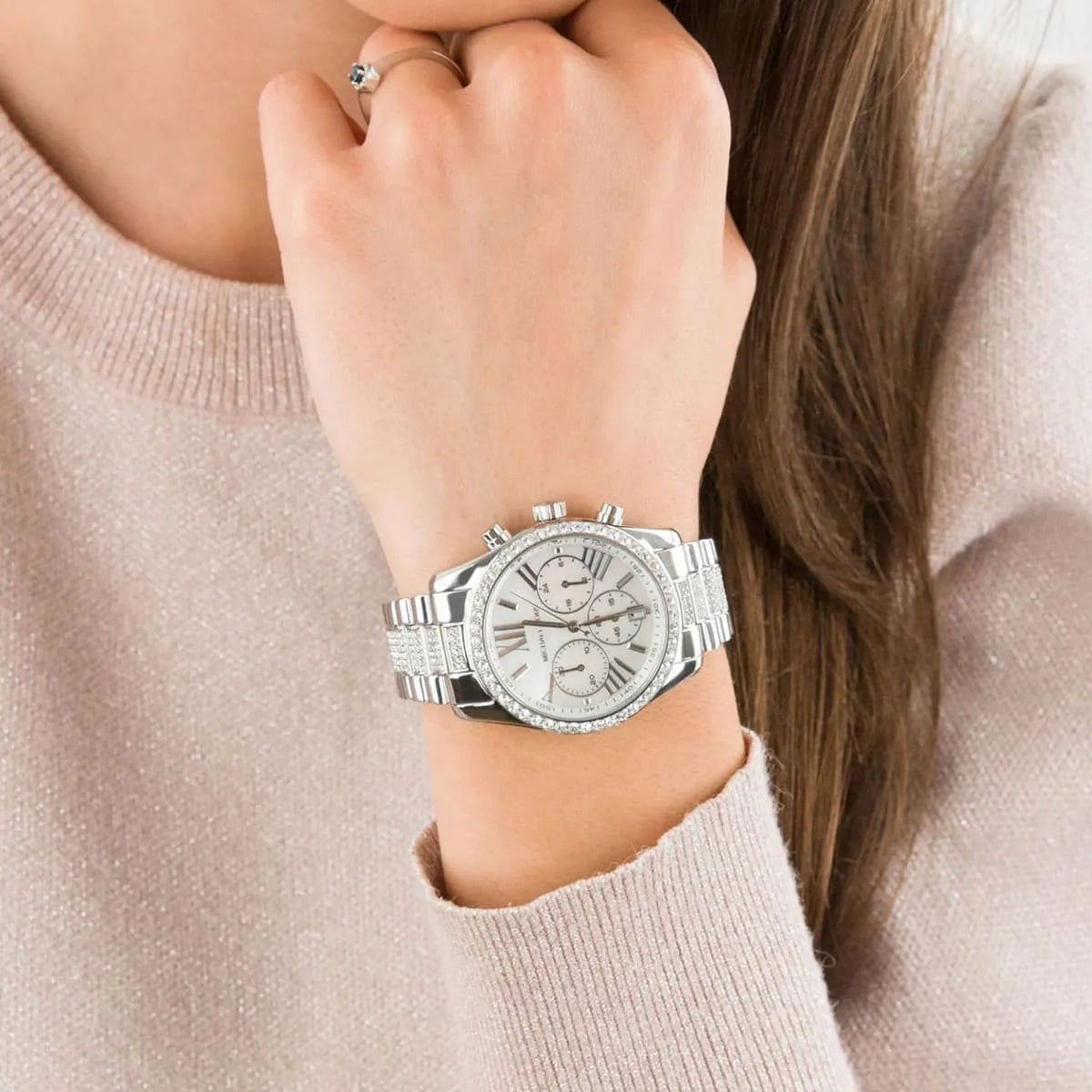 Silver-tone Lexington chronograph watch on woman's wrist showing crystal details