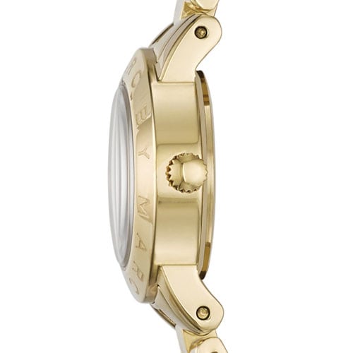 Side view of gold-tone case with engraved bezel and crown detail