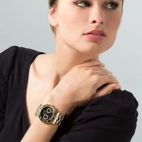 Marc By Marc Jacobs Blade watch worn on wrist with black dial and gold-tone bracelet