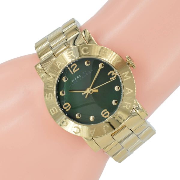 Women's Marc by Marc Jacobs watch on wrist, showing gold bracelet and teal dial face