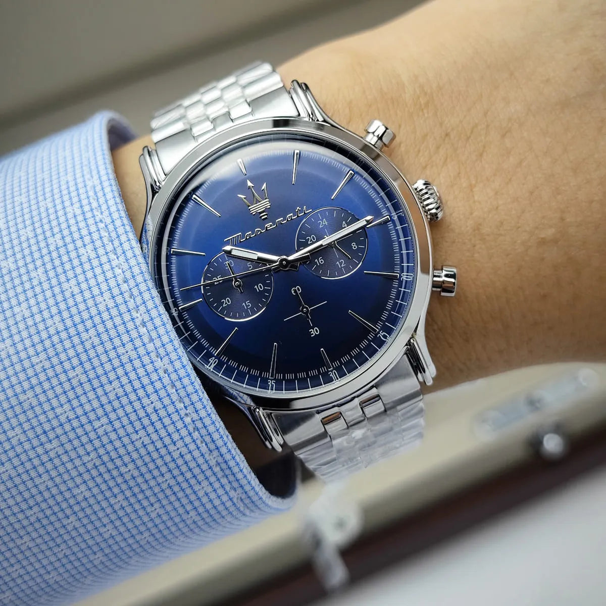 Maserati Epoca blue dial chronograph watch on wrist showing face and metal strap