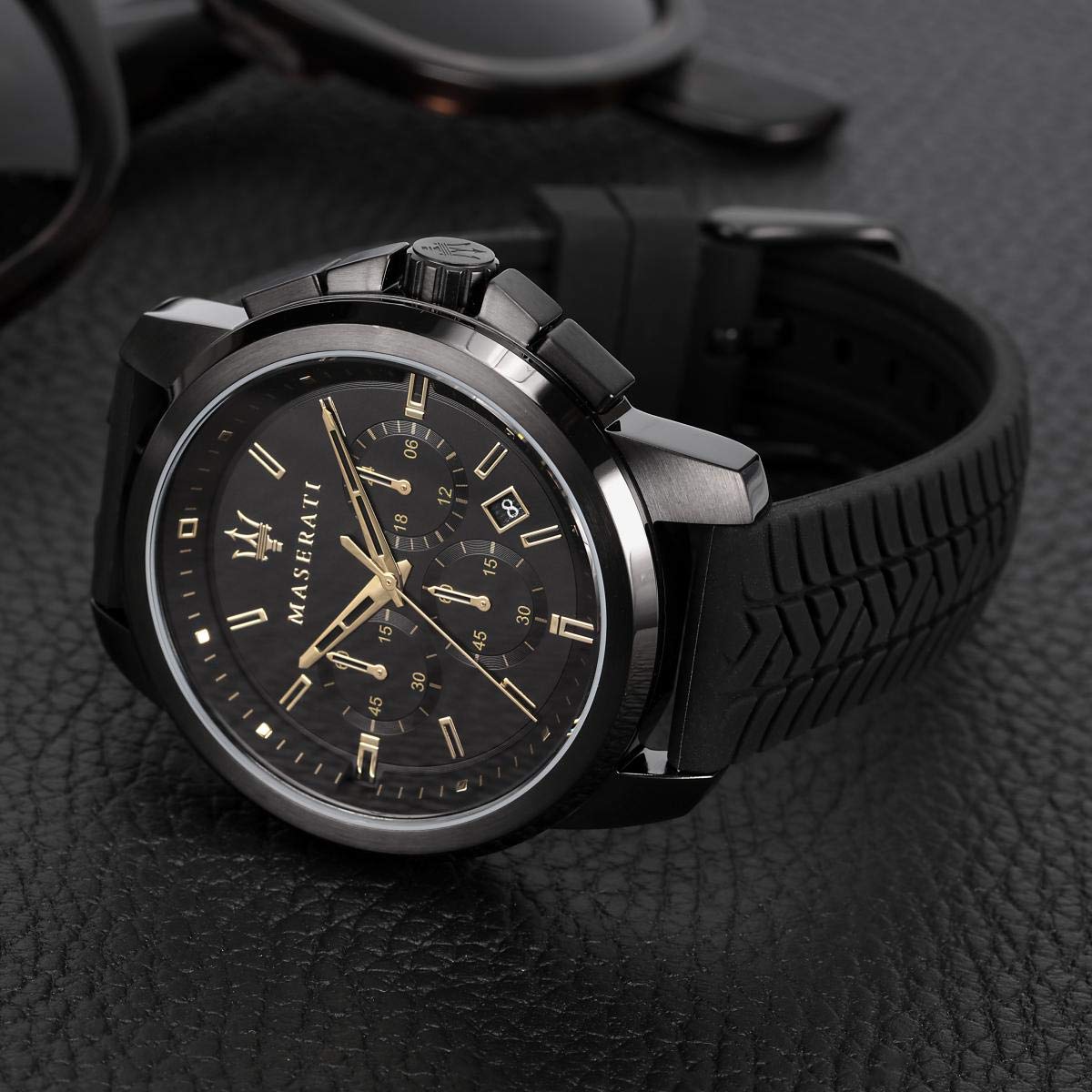 Maserati chronograph watch detail shot showing black dial and gold-tone hands
