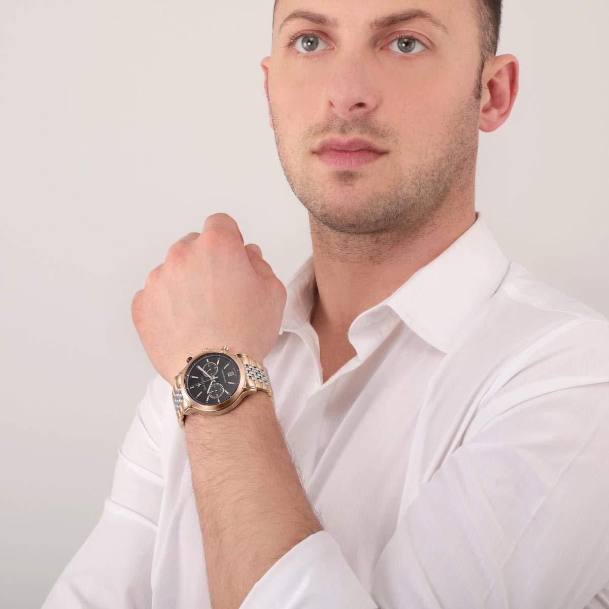 Maserati chronograph watch worn on wrist, showing black dial and two-tone bracelet in use