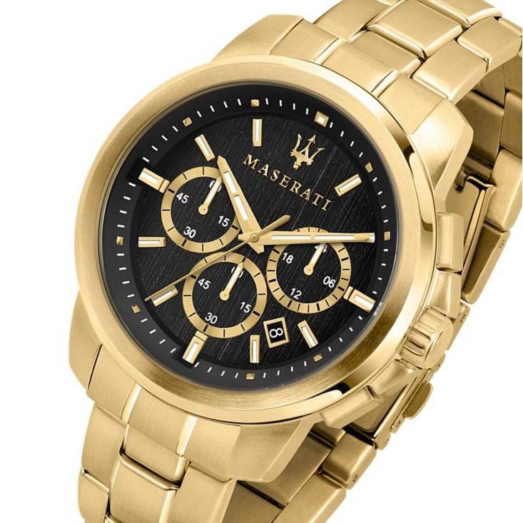 Gold chronograph watch at angle showing black dial with three subdials and gold hands
