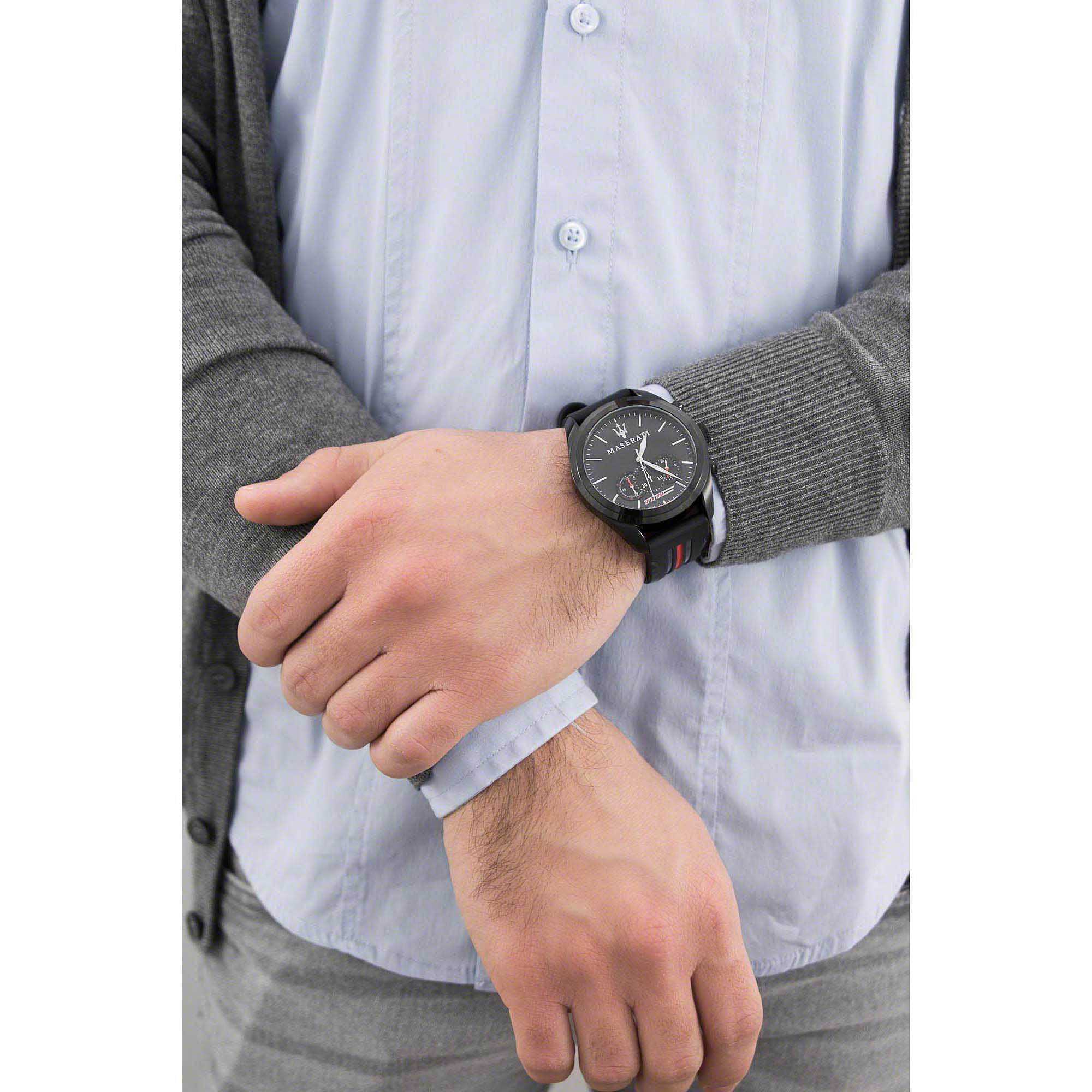Maserati Traguardo chronograph watch worn on wrist with black case and black rubber strap with red stripe