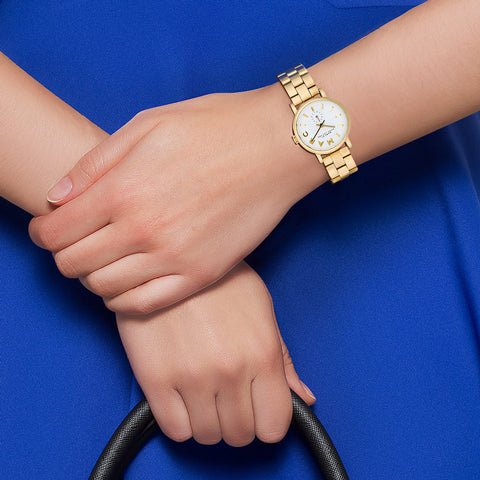 MBM3247 Marc By Marc Jacobs watch worn on wrist showing white pearlized dial and gold-tone bracelet