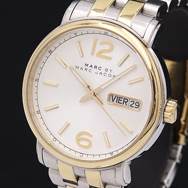 MBM8652 watch face with white dial and gold-tone indices on dark background