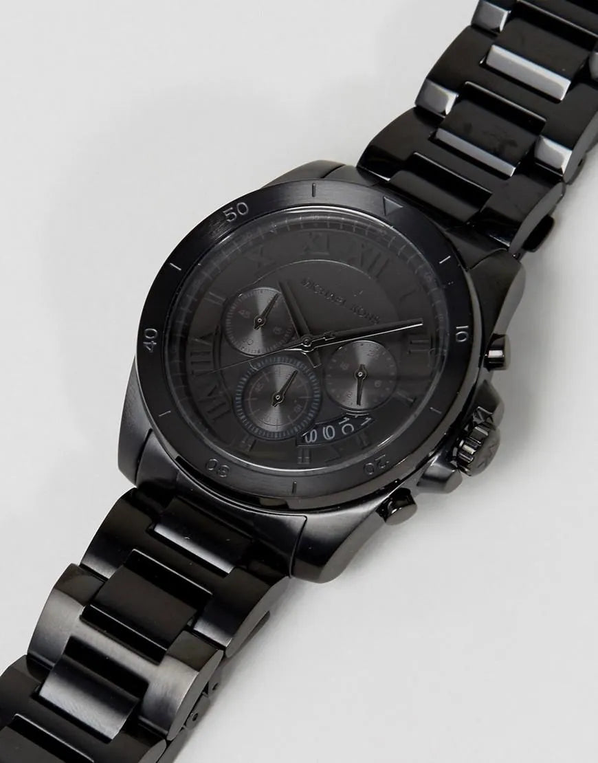 Michael Kors Alek chronograph watch worn on wrist with black steel bracelet