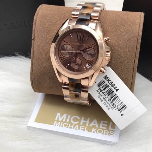 Michael Kors Bradshaw MK5944 watch on brown pillow with tag and packaging