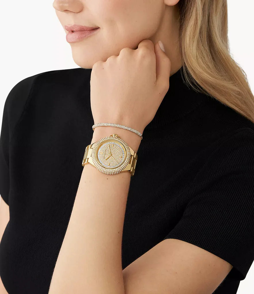 Michael Kors Camille gold crystal watch worn on wrist with gold strap