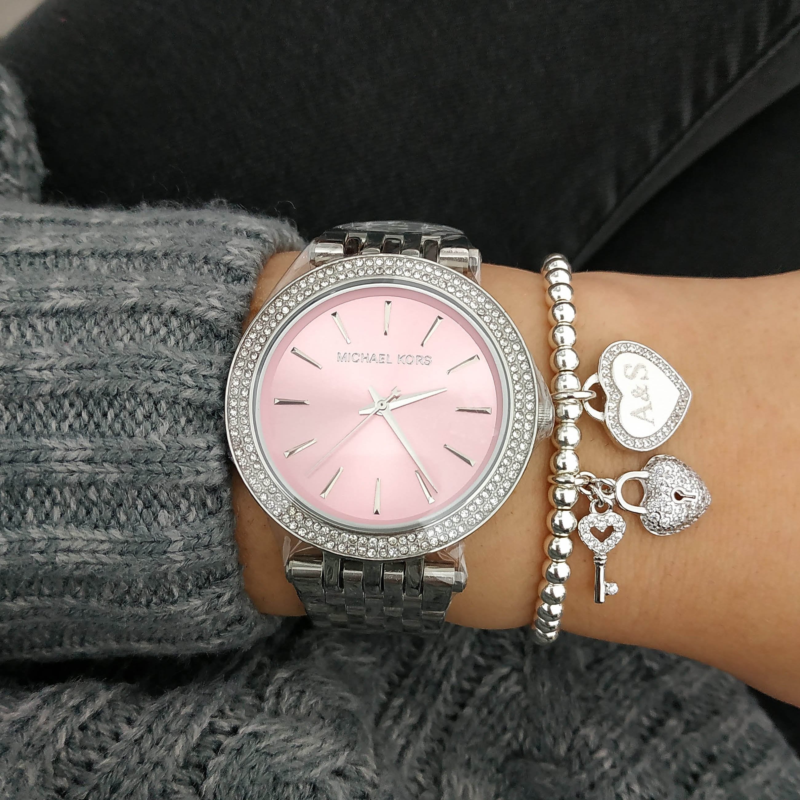 Michael Kors Darci MK3352 watch on wrist with charm bracelet