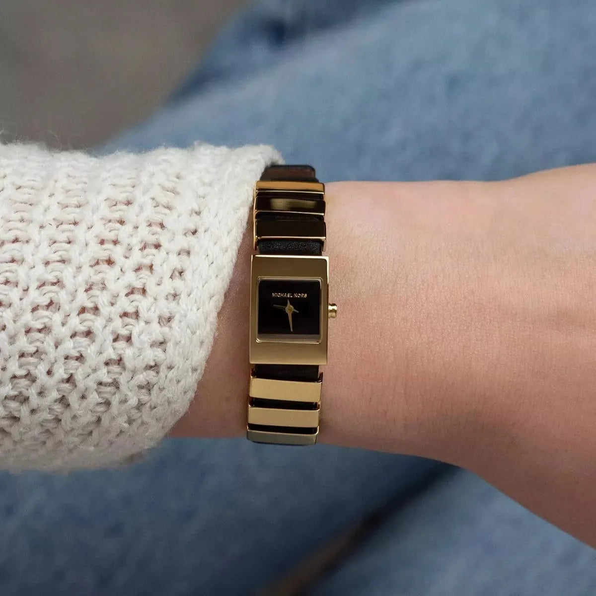 Michael Kors Darrington MK4887 worn on wrist showing square black dial and gold/black striped band