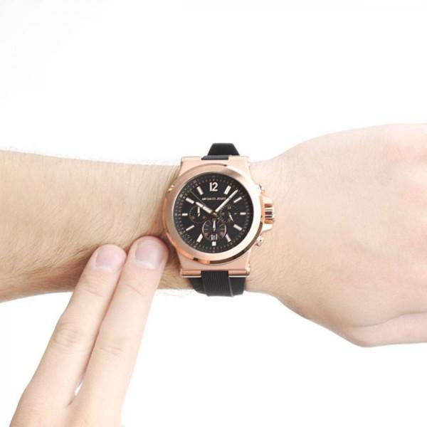 Michael Kors Dylan chronograph worn on wrist showing black dial and rose gold case