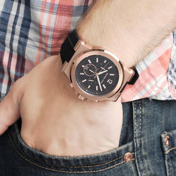 Michael Kors Dylan chronograph on wrist featuring black dial and rose gold finish