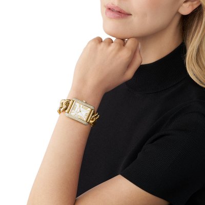 Michael Kors Emery MK7300 watch worn on wrist showing gold-tone rectangular case and link bracelet